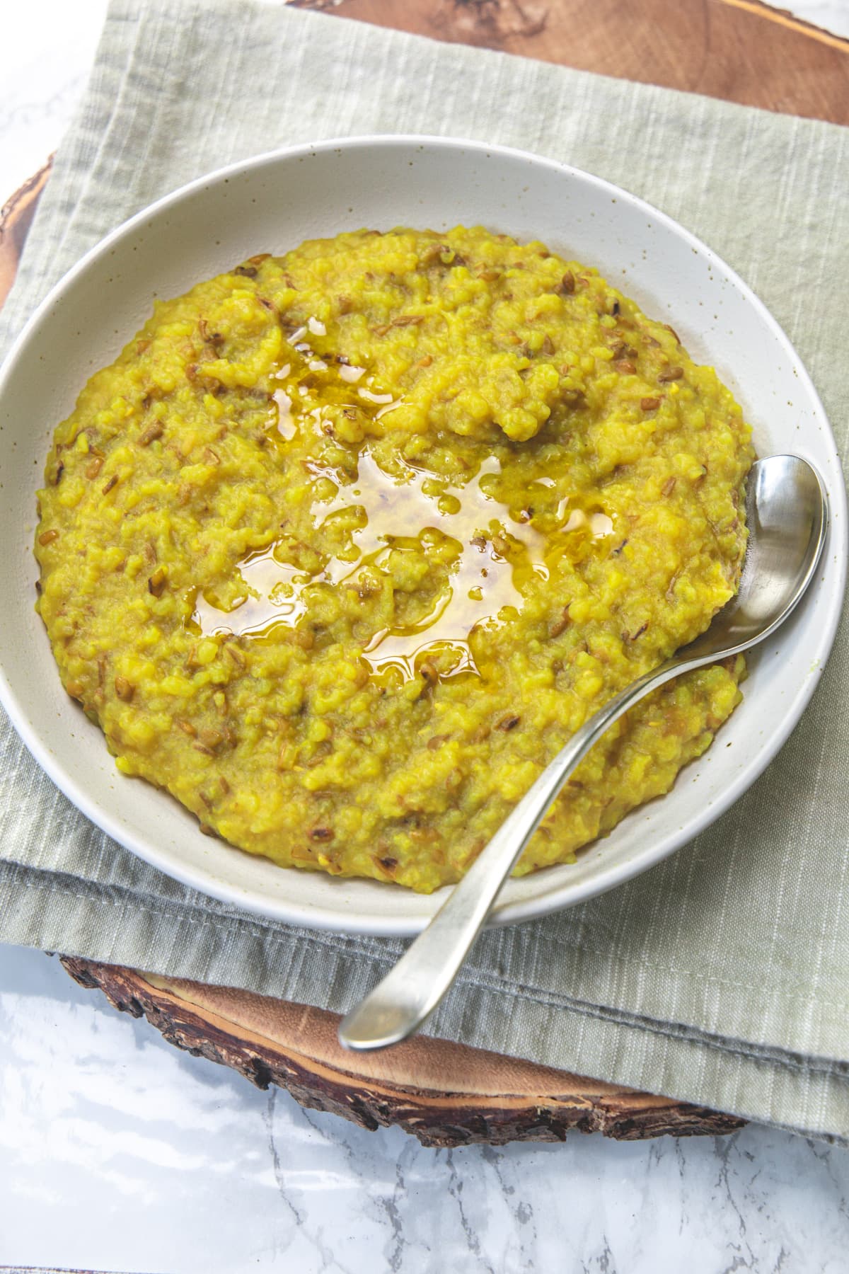 Gujarati khichdi served in a plate, topped with ghee.