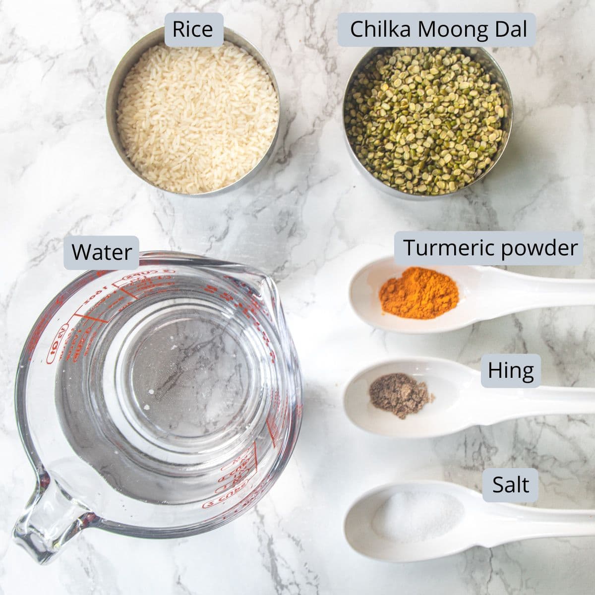 Gujarati khichdi ingredients in bowls and spoons with labels.