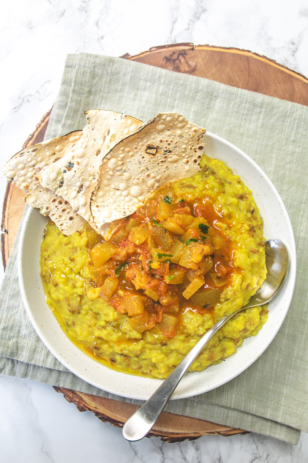 A plate of gujarati khichdi, lauki shaak with papad.