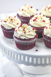 Eggless red velvet cupcakes on a cake stand.