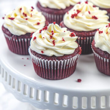 Eggless red velvet cupcakes on a cake stand.