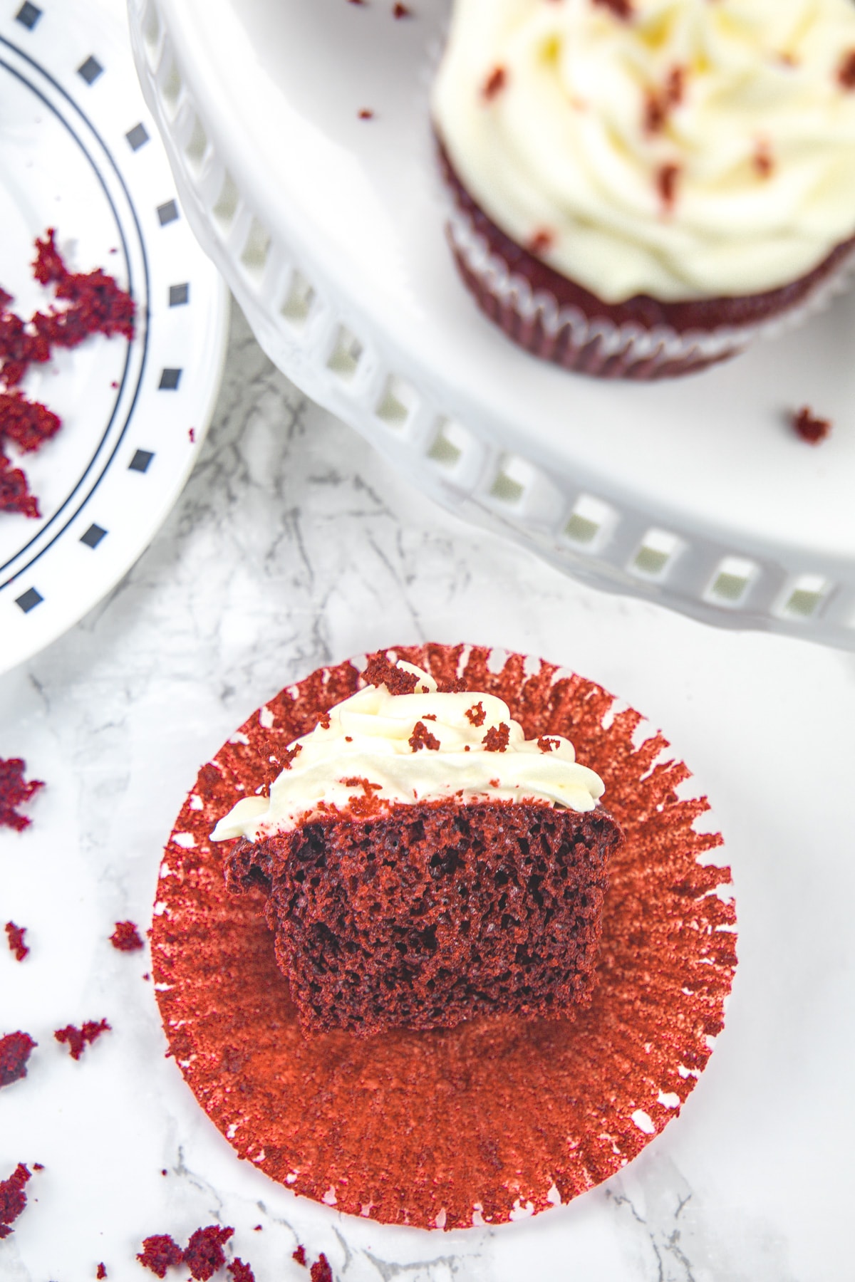 Eggless red velvet cupcake cut into half to show inside texture.