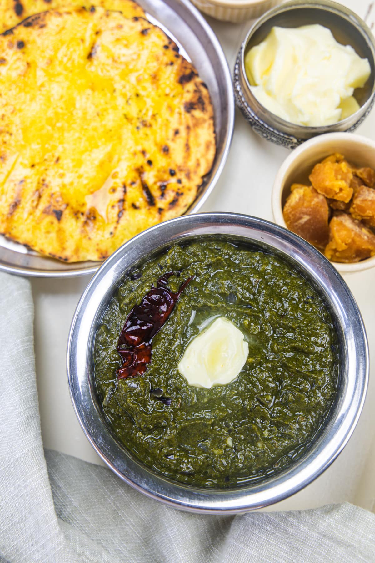 Sarson ka saag with makki ki roti, jaggery, onion and butter.