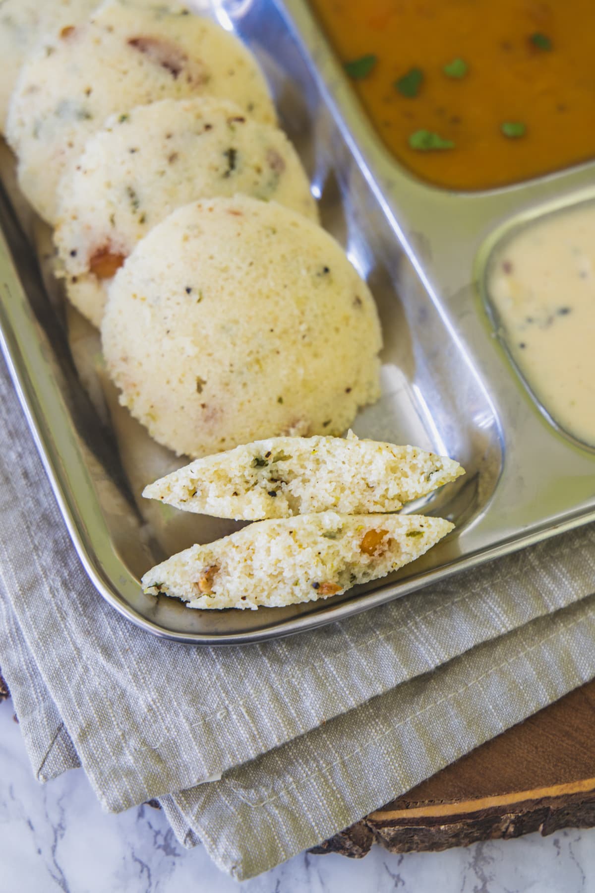 One rava idli cut into half to show inside texture.