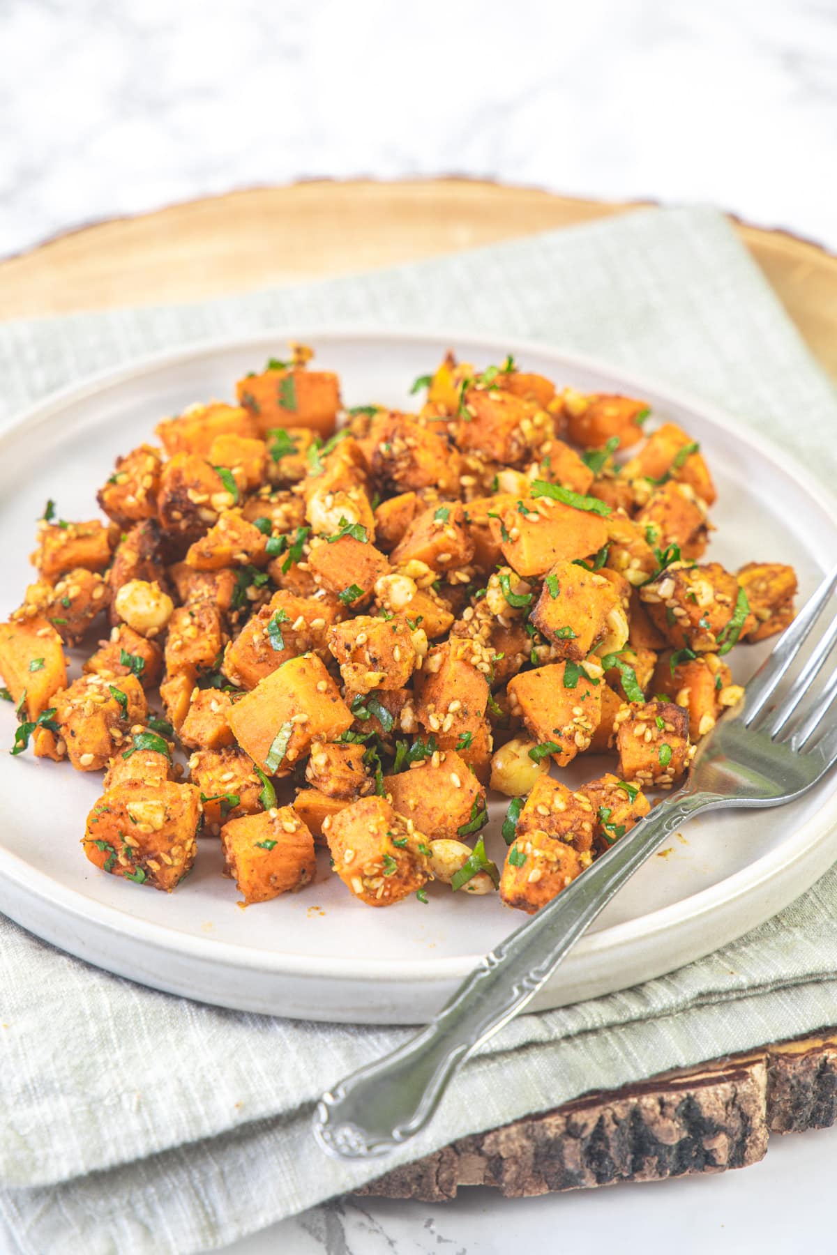 A plate of sweet potato chaat with fork.