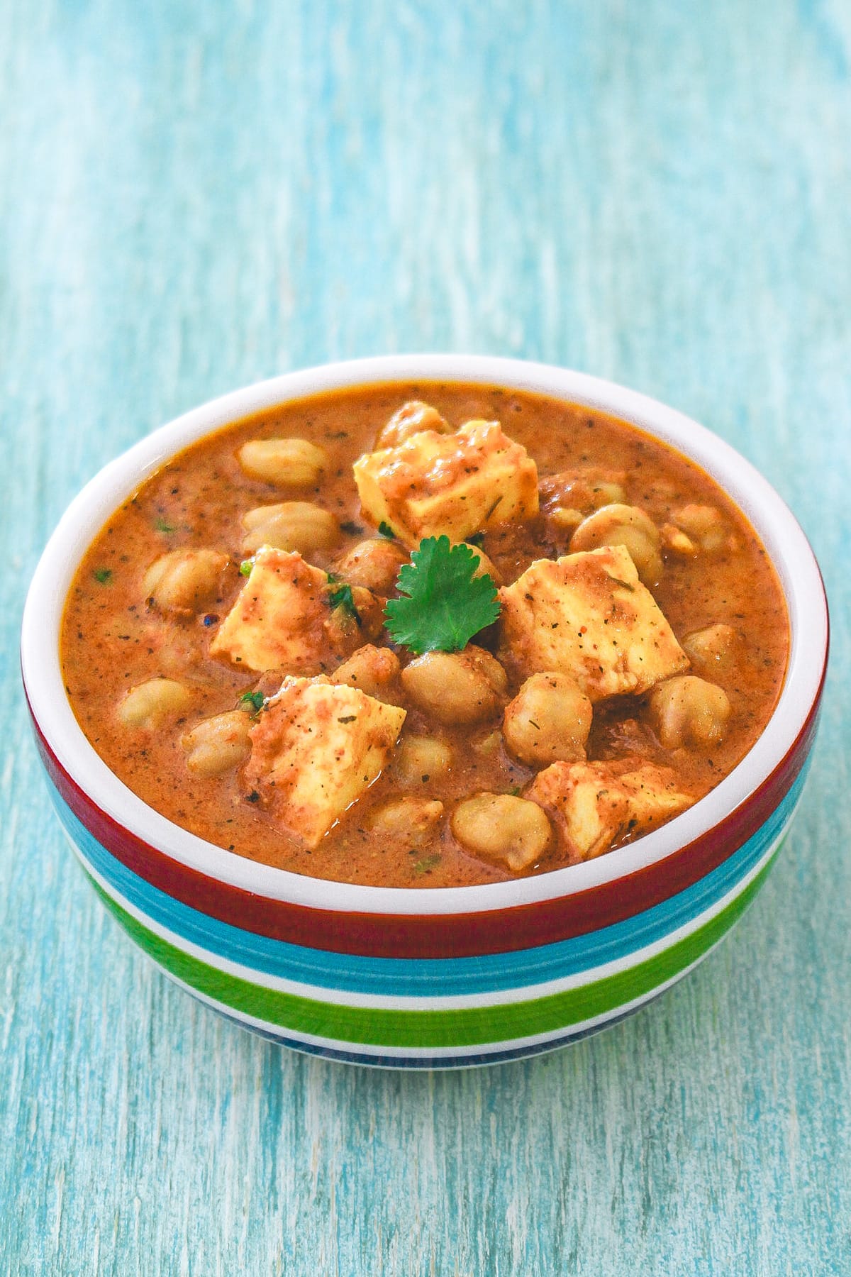 Chana paneer in a bowl and garnished with cilantro.