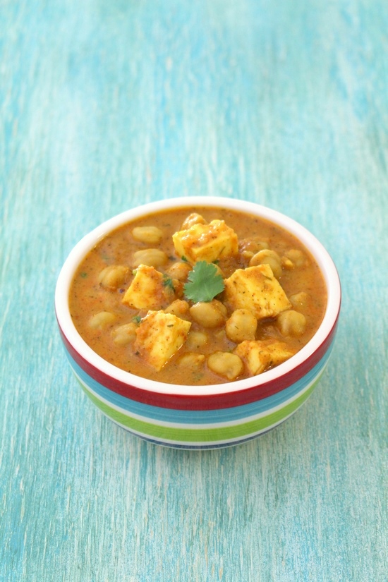 Chana paneer served in a bowl with a garnish of cilantro.
