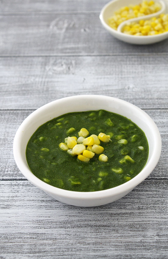 Corn palak in a bowl topped with more sweet corn.