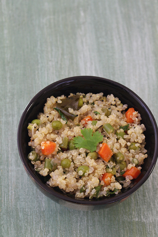 Quinoa upma in a bowl with a garnish of cilantro.