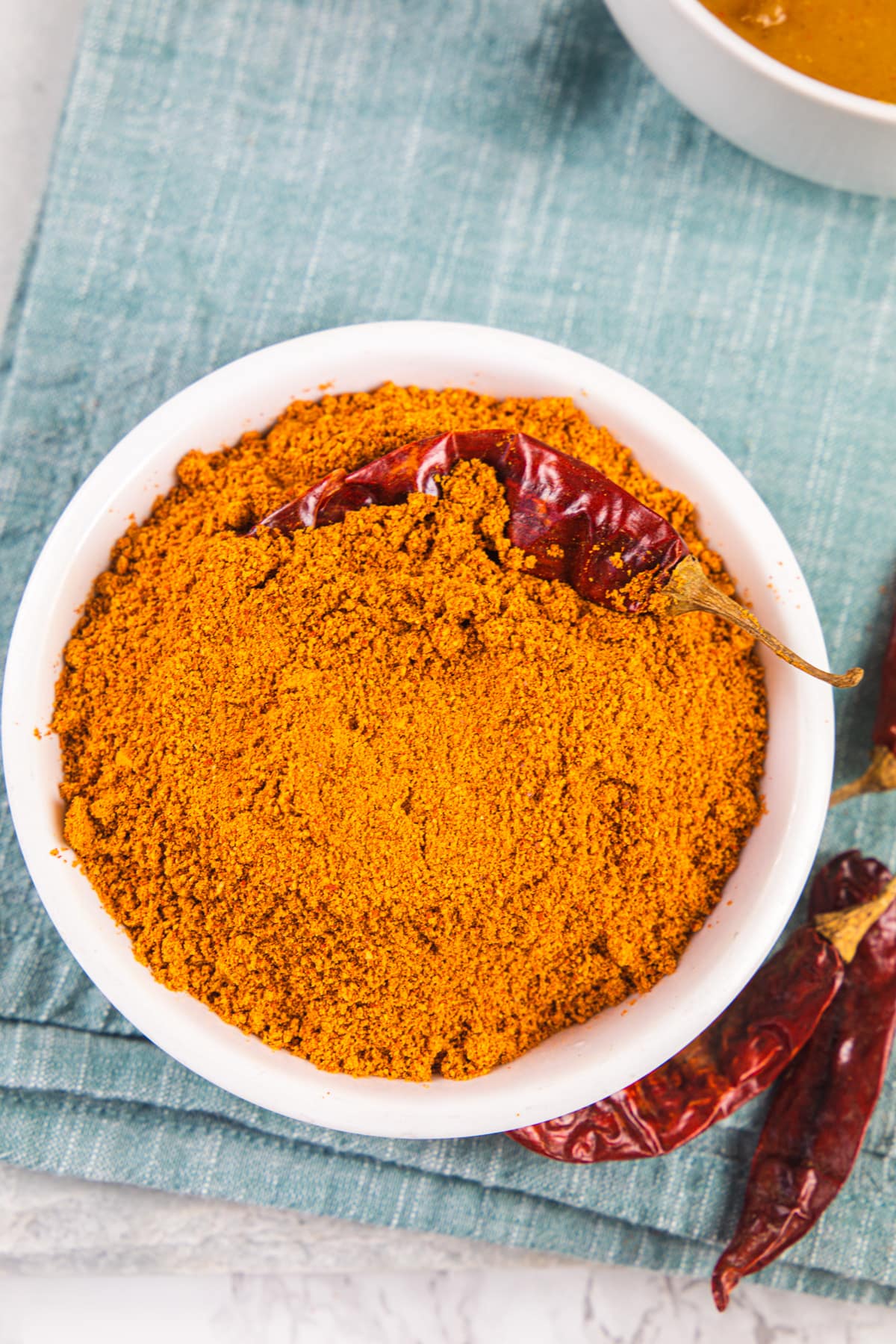 Sambar powder in a bowl garnished with dried chili.