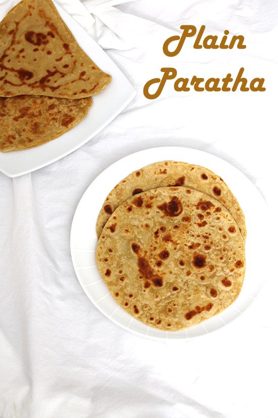 2 round plain paratha in a plate with 2 triangle parathas in another plate with label on the image.