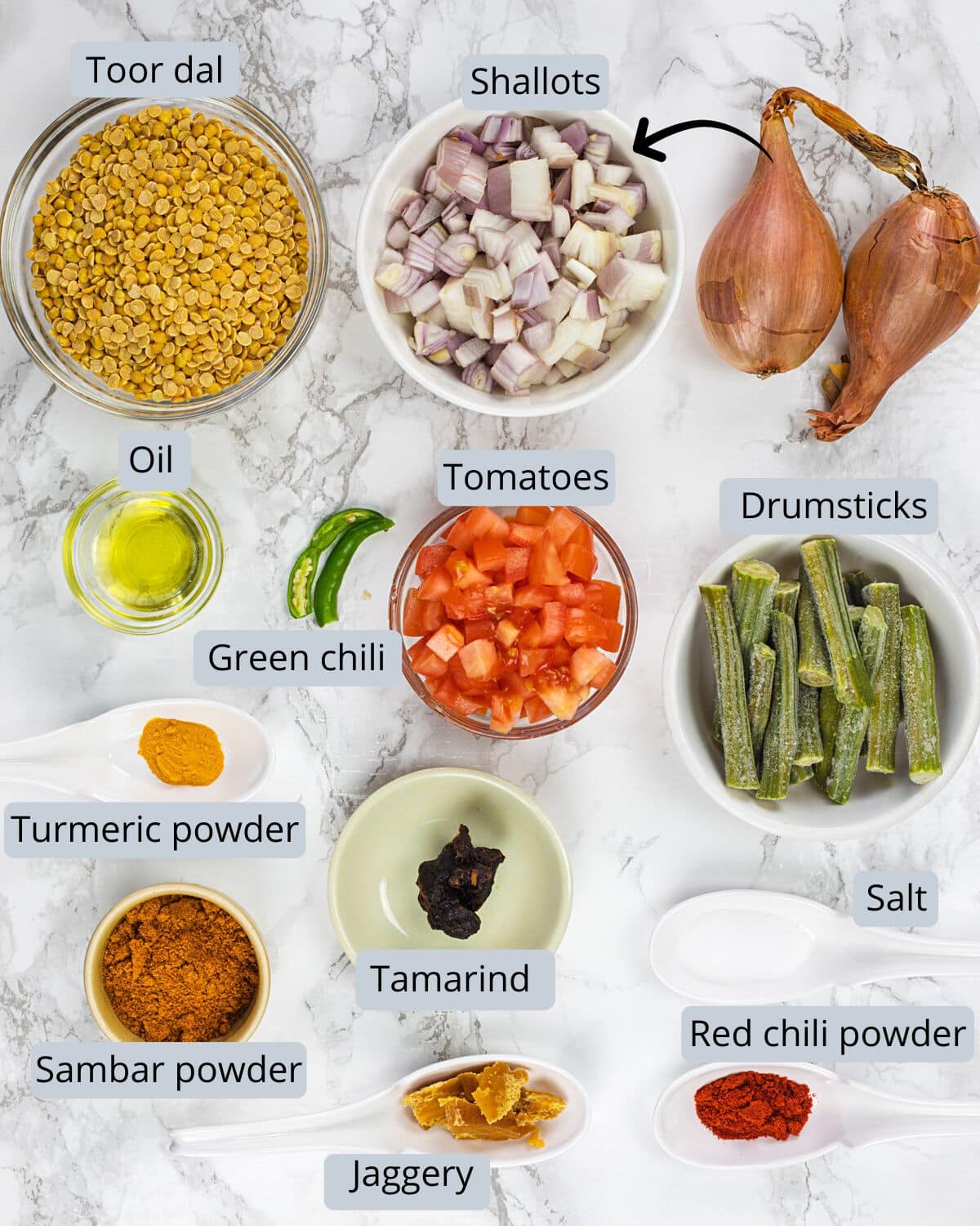 Instant pot sambar ingredients in bowls and spoons with labels.