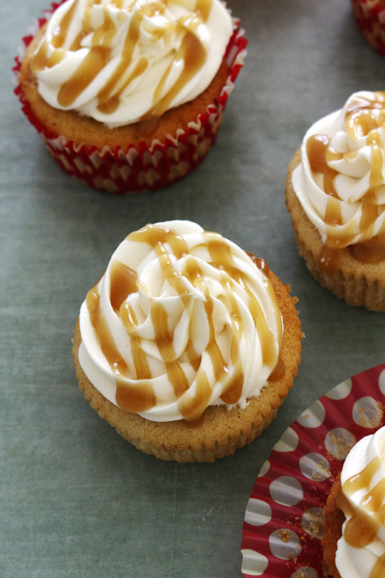 Eggless butterscotch cupcake recipe with a drizzle of butterscotch sauce on top.