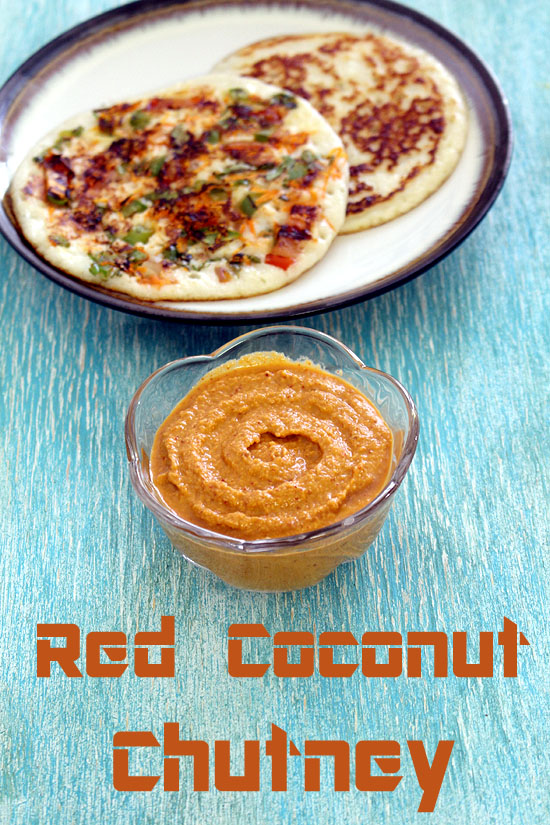 Red coconut chutney in a bowl with a plate of uttapam in the back.