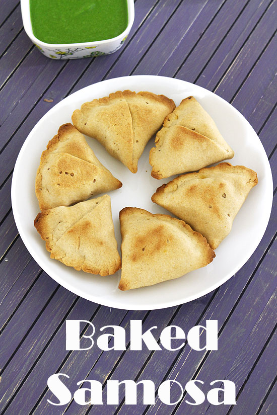 Baked samosa in a plate with cilantro chutney in the back.