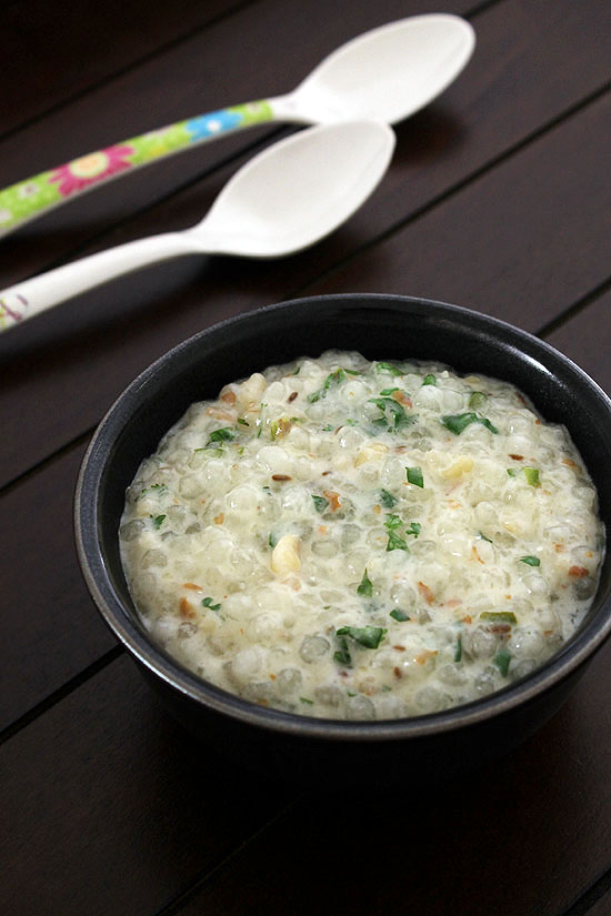 Dahi sabudana served with a black bowl with spoons in the back.