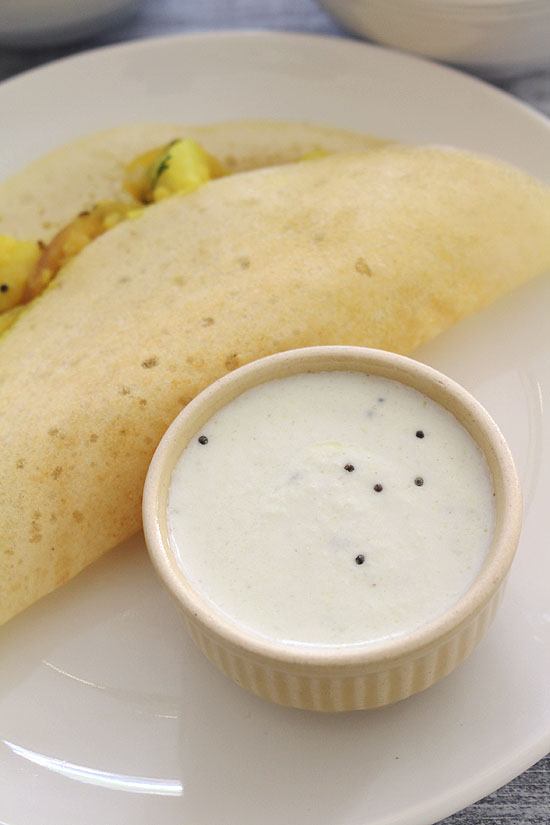 Coconut curd chutney served in a small bowl with masala dosa.