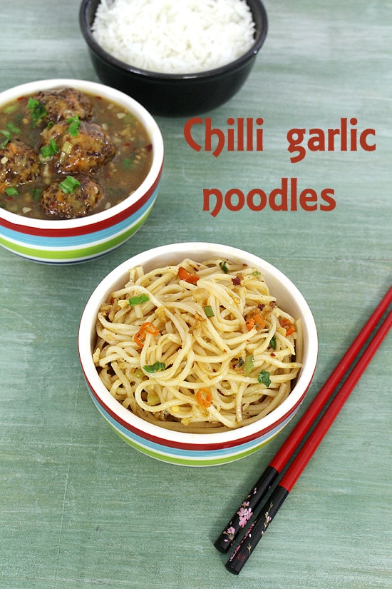 Chilli garlic noodles served with veg manchurian and rice with chopsticks on the side.