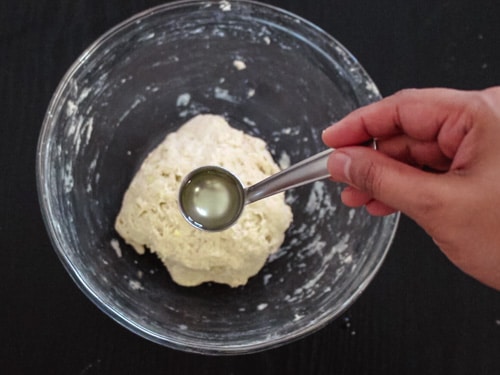 adding oil to the dough