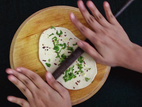 lightly rolling the garlic naan