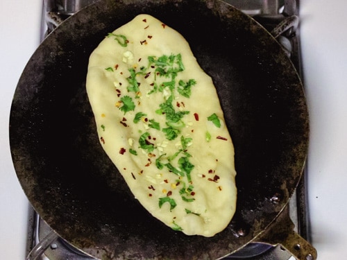 rolled naan on hot cast iron skillet