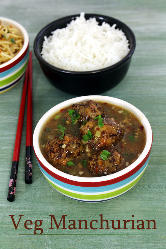 Veg manchurian gravy served with rice and chopsticks on the side.