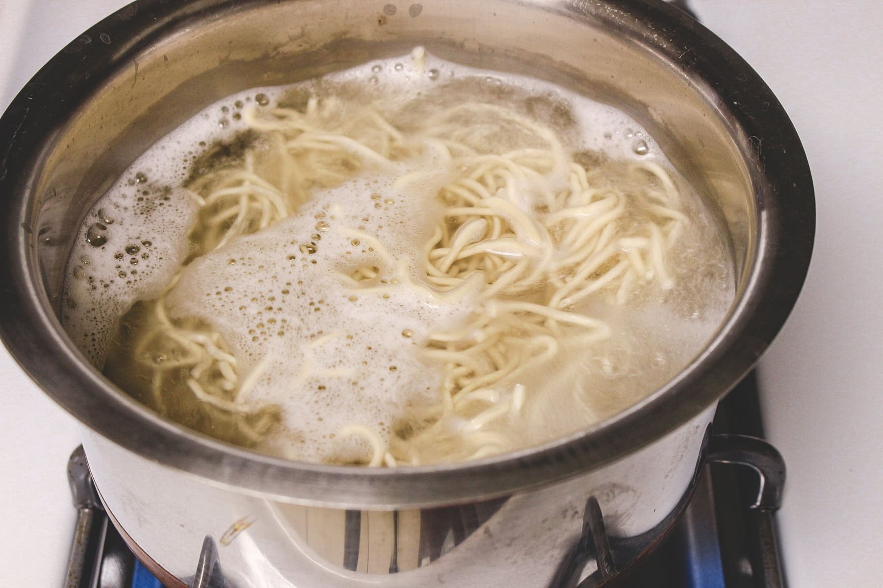 Noodles boiling on a pan.
