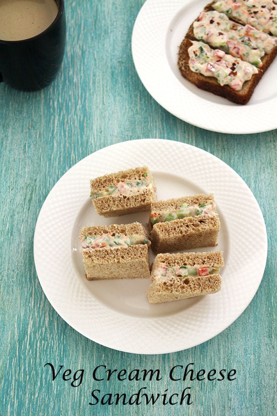 4 pieces of veg cream cheese sandwich in plate.