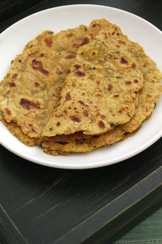 Leftover dal paratha in a plate with first one folded in half.