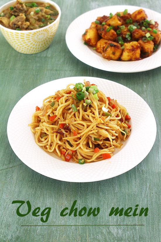 Veg Chow Mein served in a plate with paneer manchurian and mushroom manchurian in the back.