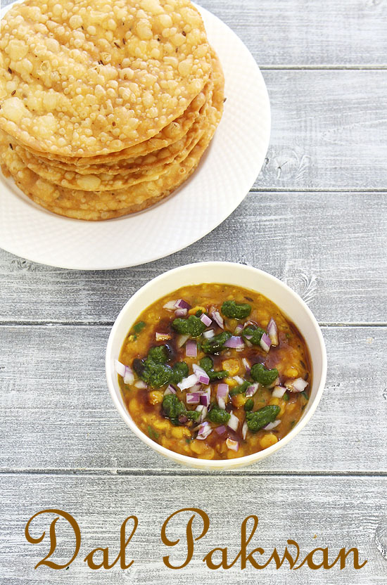 Dal topped with 2 chutney, onion and pakwan in the back.