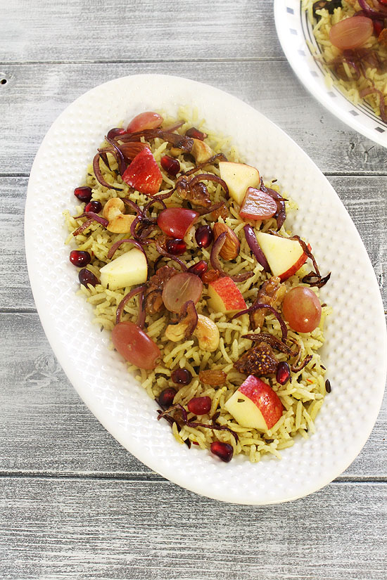 Kashmiri pulao topped with fruits and fried onion.