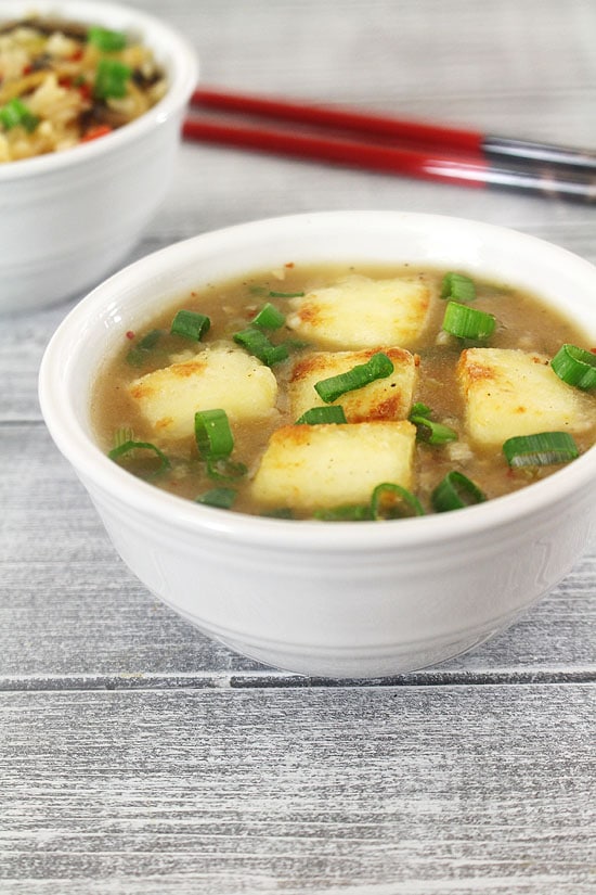 Paneer Manchurian garnished with spring onion greens.