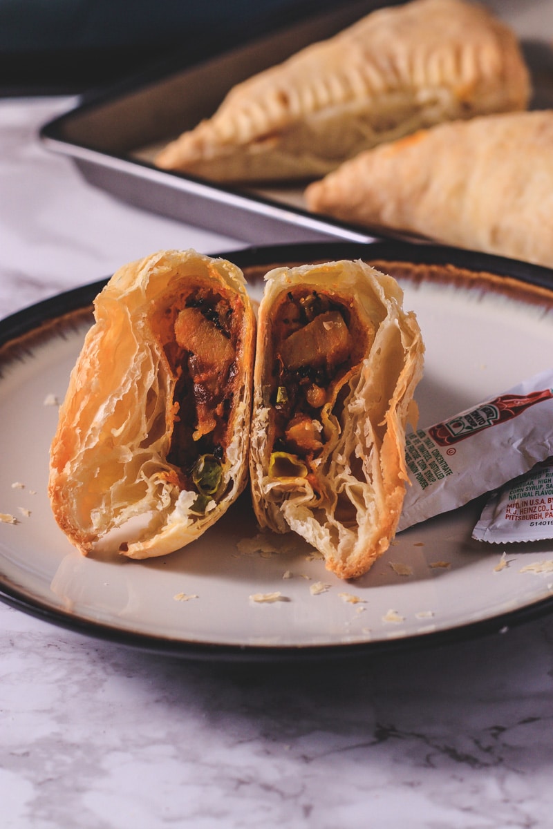 half cut vegetable puff in a plate