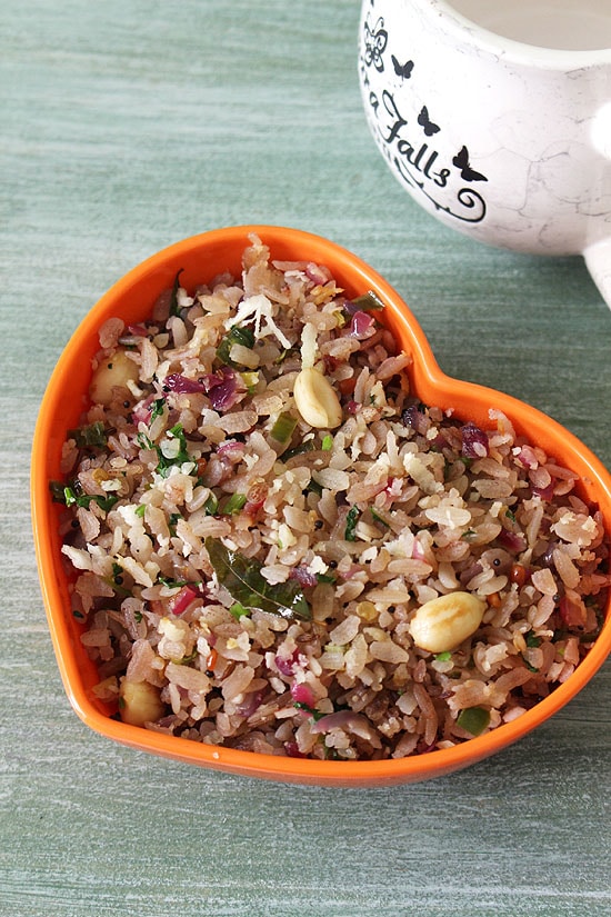 Poha upma in a bowl and a cup in the back.