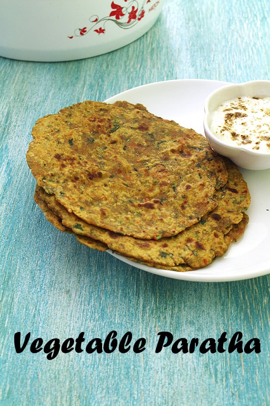 2 vegetable paratha with a bowl of yogurt.