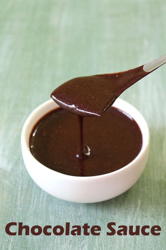 Pouring chocolate sauce using a spoon back into the bowl.