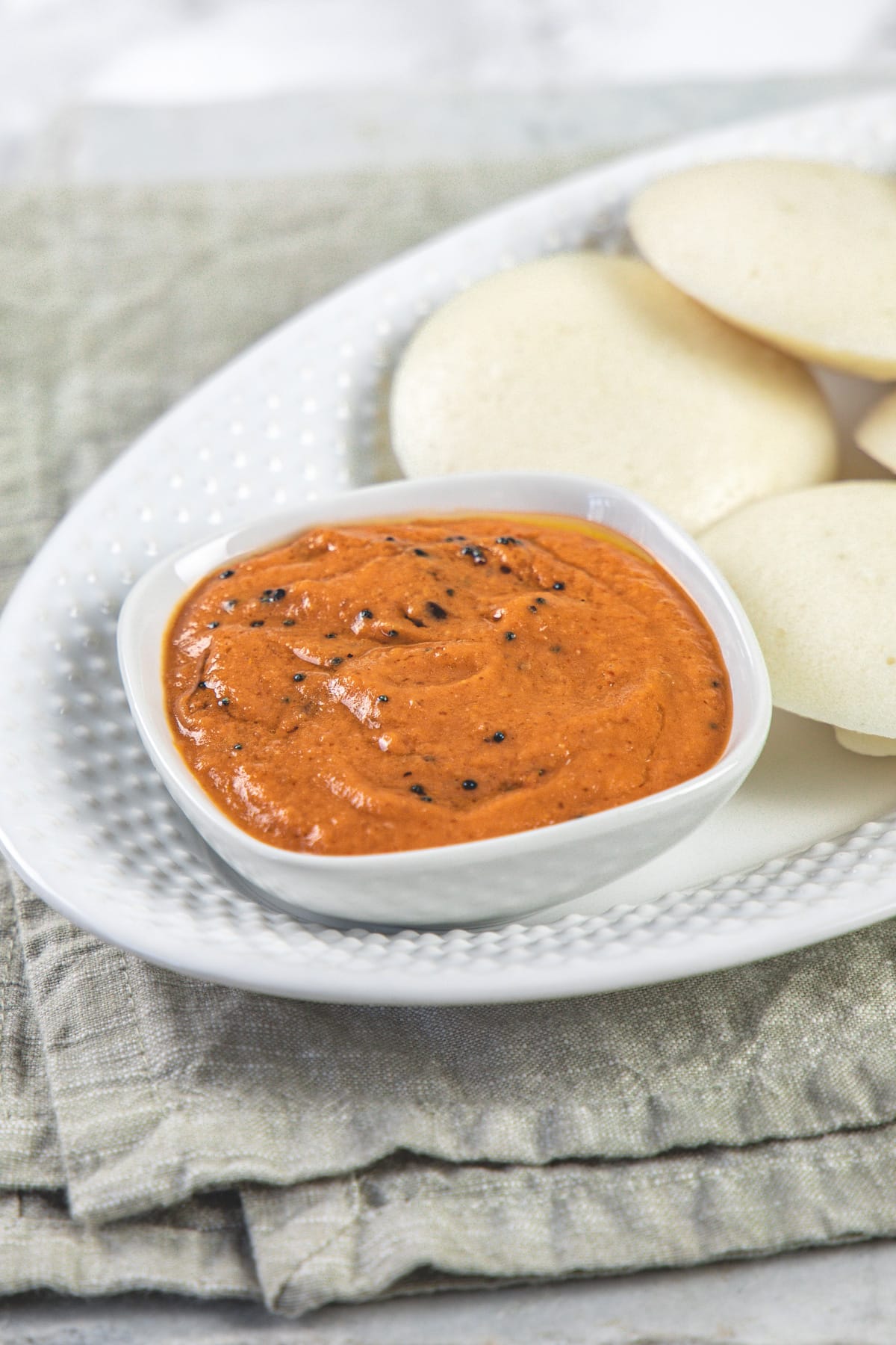 Tomato chutney served with idli.