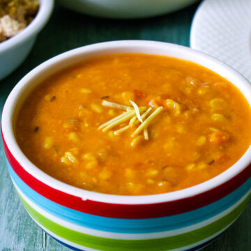 Panchmel dal bowl garnished with julienne ginger.