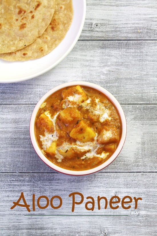 Aloo paneer served in a bowl with a drizzle of cream and paratha in the back.