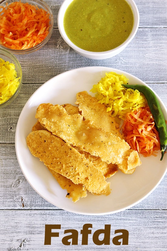 Fafda served with papaya sambharo, fried chili and fafda chutney.