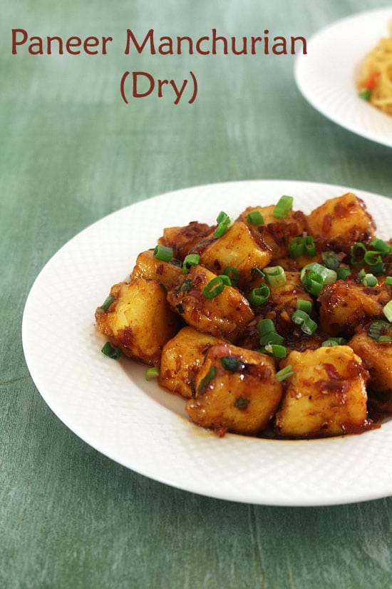 Paneer Manchurian Dry served in a plate and garnished with spring onion greens,