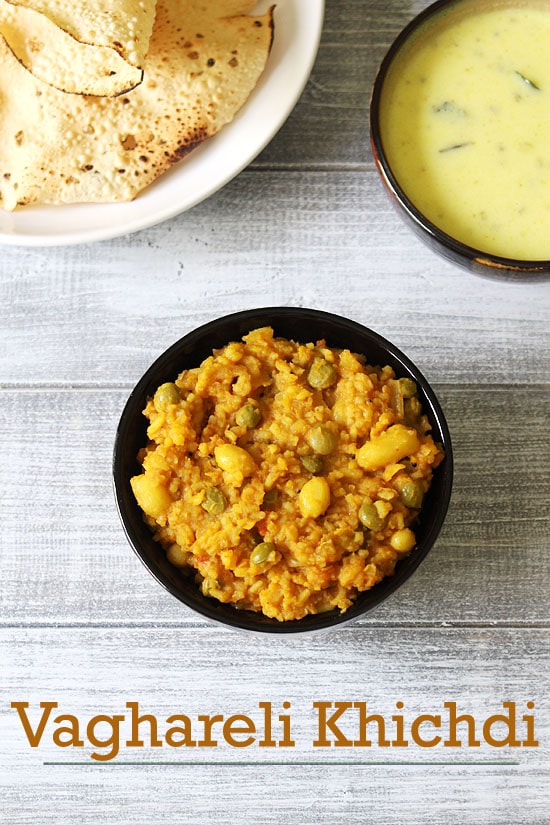 A bowl of vaghareli khichdi served with kadhi and roasted papad.