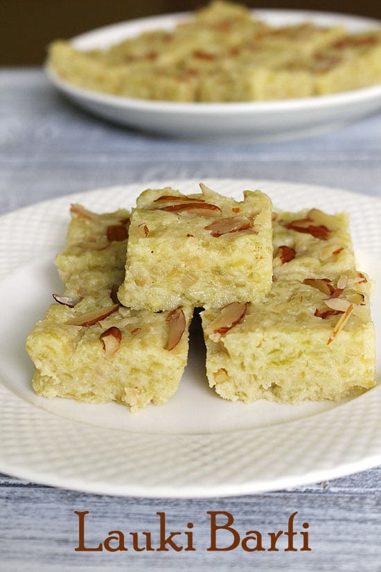 A stack of lauki barfi on a plate with another plate in the back.