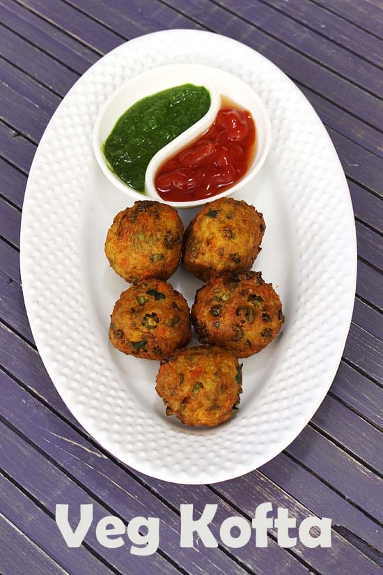 Veg Kofta served with ketchup and green chutney.