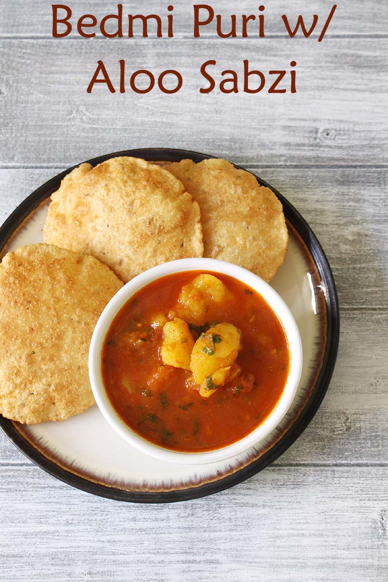 Bedmi aloo served in a bowl with bedmi puri in a plate.