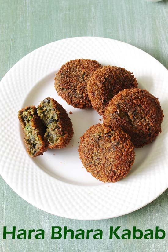 Hara bhara kabab served in a plate with one cut open in half.