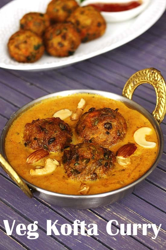 Veg kofta curry garnished with fried nuts.