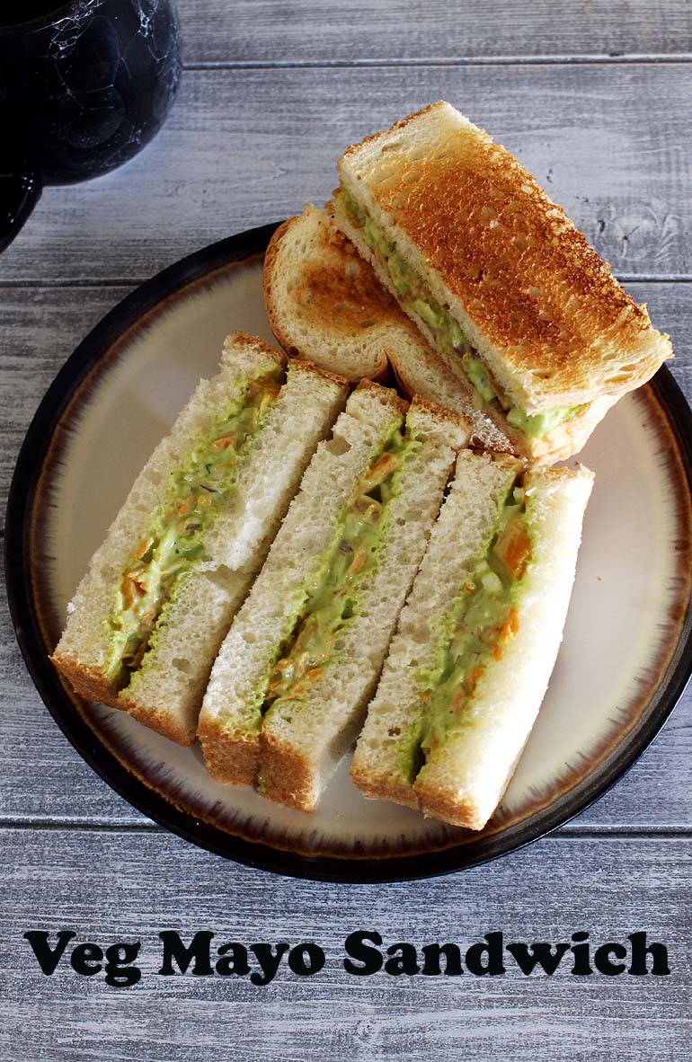 Veg mayonnaise sandwich halves served on a plate.