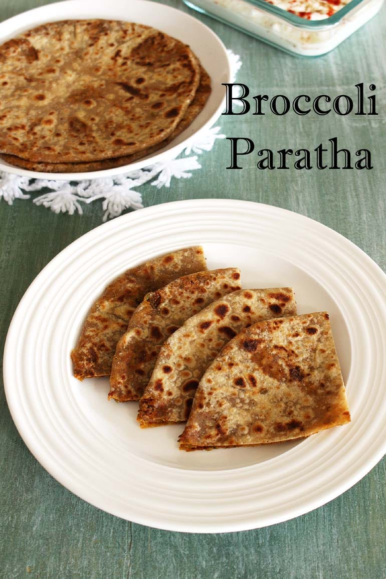 Broccoli paratha triangles served in a plate, more paratha in the back.